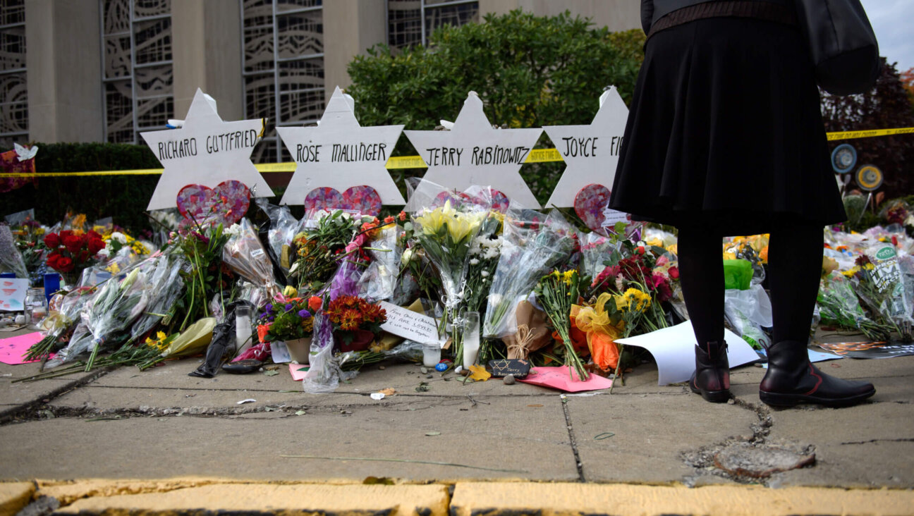 Mourners visit the memorial outside the Tree of Life Synagogue on October 31, 2018 in Pittsburgh, Pennsylvania, where eleven Jews were killed in a mass shooting.