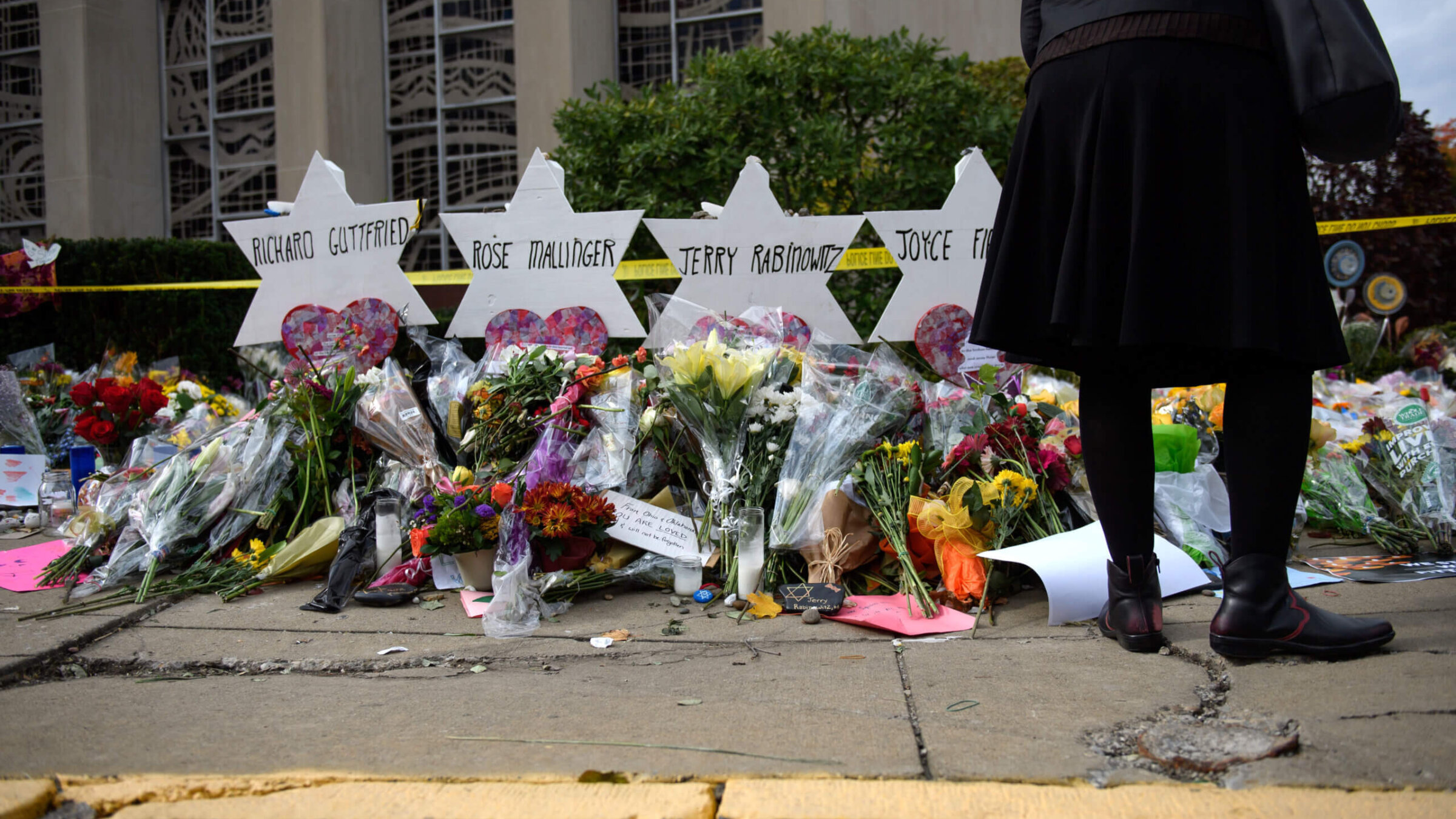 Mourners visit the memorial outside the Tree of Life Synagogue on October 31, 2018 in Pittsburgh, Pennsylvania, where eleven Jews were killed in a mass shooting.