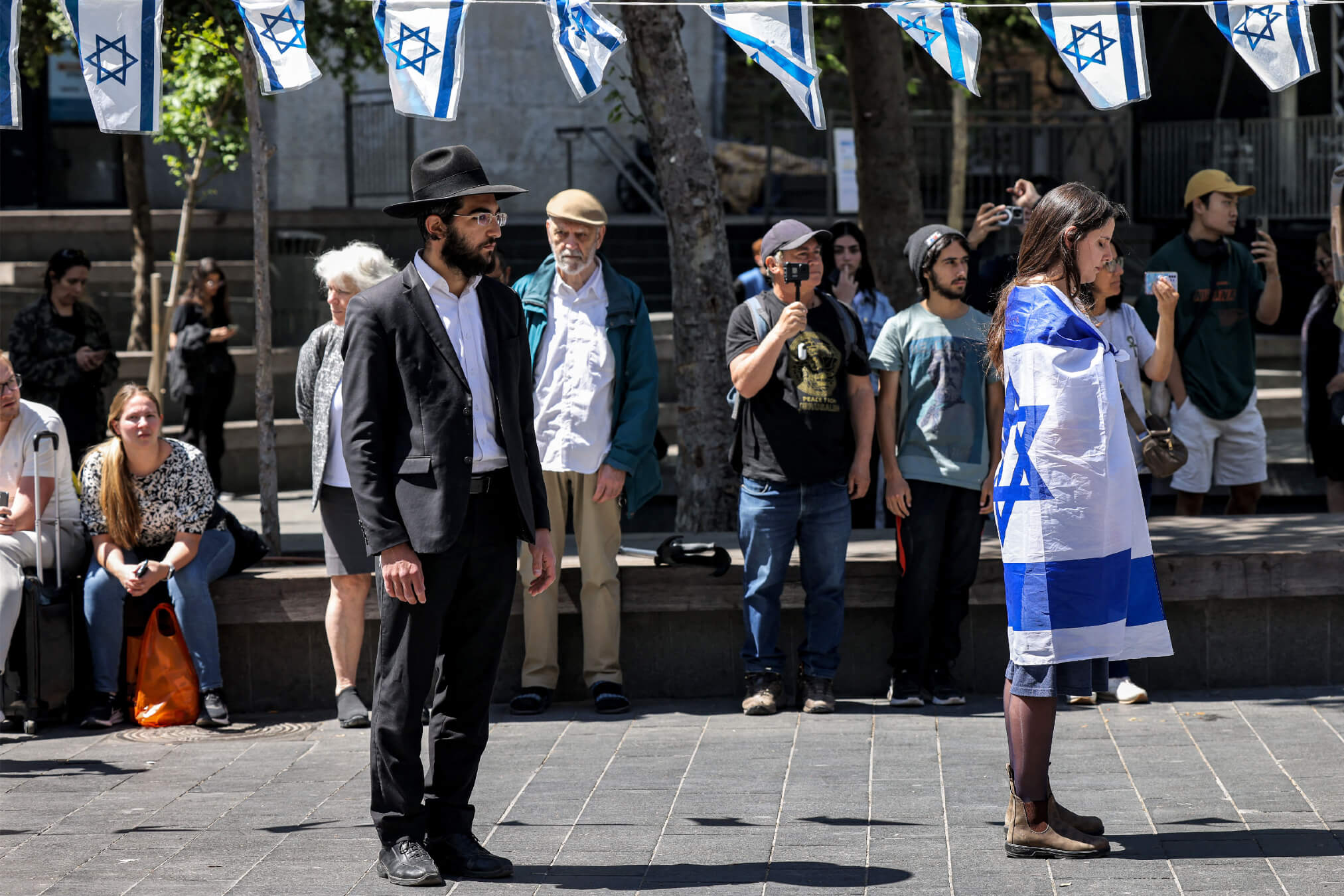 People stop and stand in silence in Jerusalem on April 25, 2023, as sirens wail for two minutes on Israel's Day of Remembrance.