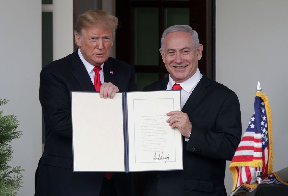 President Donald Trump and Prime Minister of Israel Benjamin Netanyahu show members of the media the proclamation Trump signed recognizing Israel’s sovereignty over Golan Heights after a meeting outside the West Wing of the White House March 25, 2019 in Washington, DC.